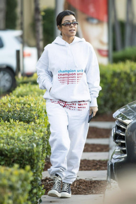 Kourtney Kardashian in Grey Sweatsuit Hoodie, Black High-Top Sneakers and Dark S
